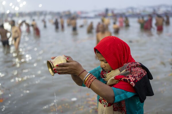 A Hindu devotee prays before taking a dip at the confluence of the Ganges, the Yamuna and the mythical Saraswati rivers on the first day of the 45-day-long Maha Kumbh festival in Prayagraj, India, Monday, Jan. 13, 2025. (AP Photo/Ashwini Bhatia)